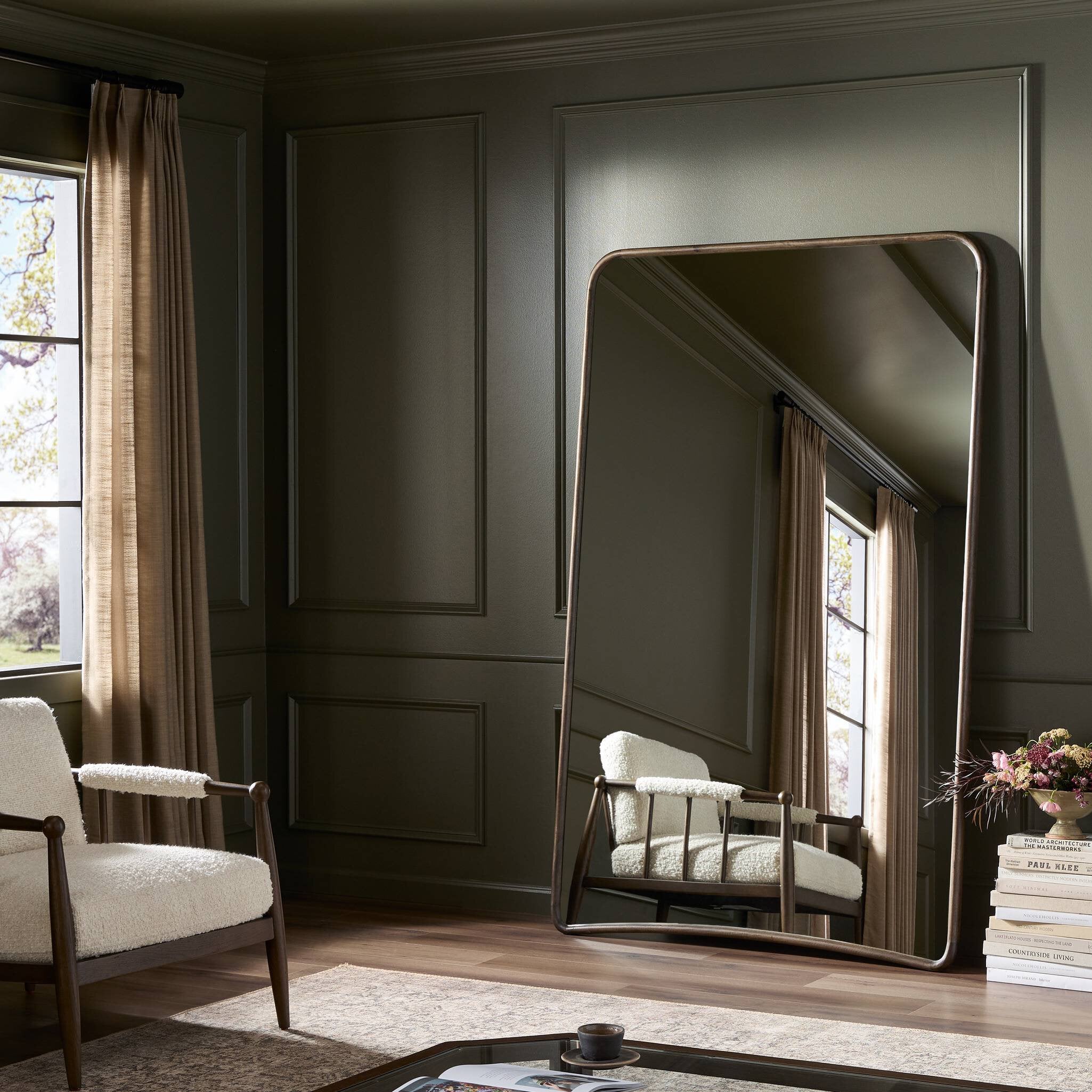 Madrano Floor Mirror in Aged Brown styled leaning in a living room