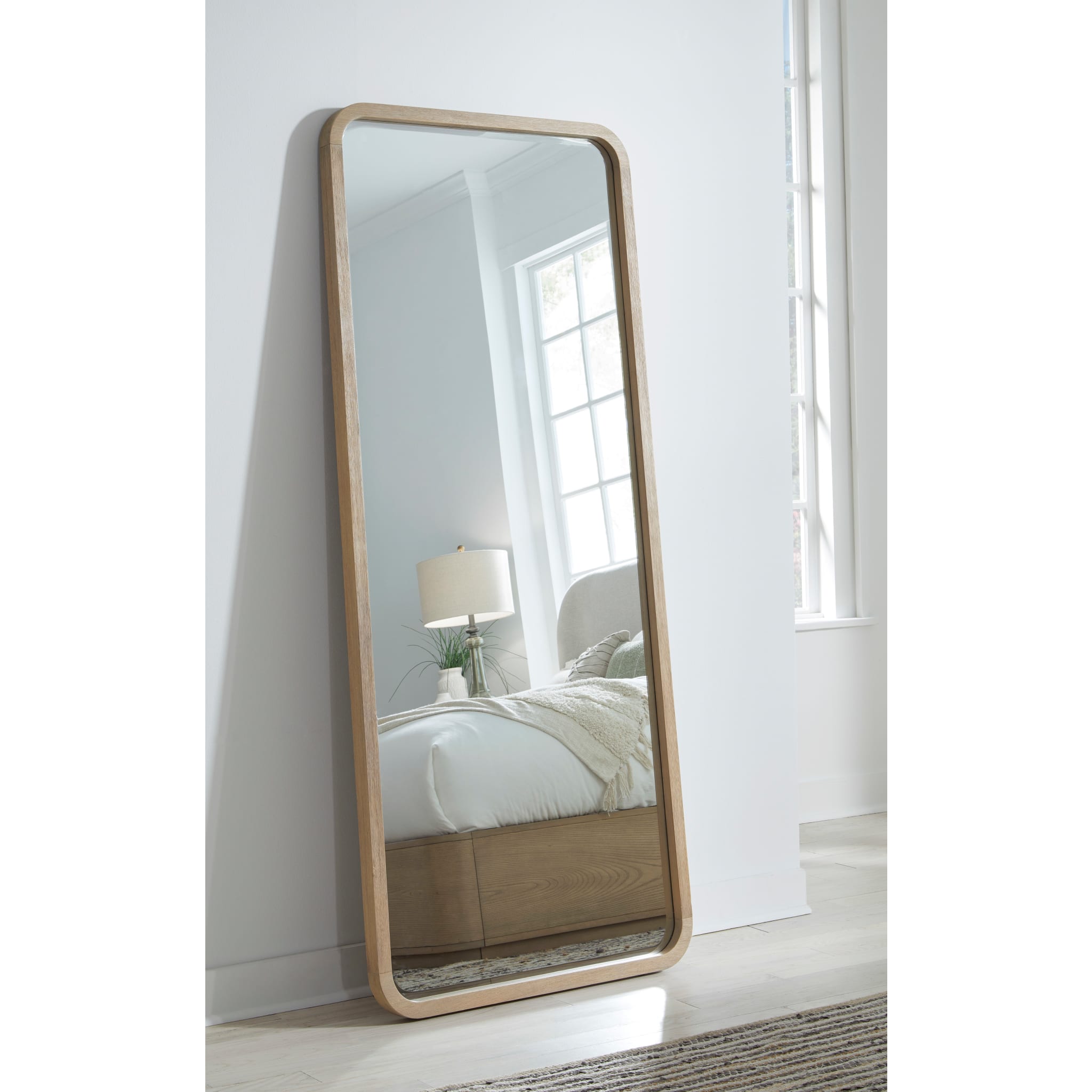 Penny Floor Mirror leaning in a bedroom